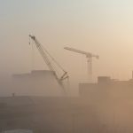 A picture of cranes in a dusty landscape